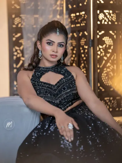 A seated pose that showcases the intricate details of the outfit and makeup.