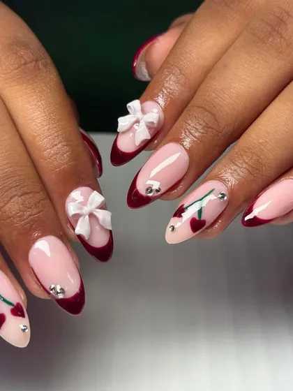 I love adding playful, trendy details to my nail sets. This design features a classic French tip in a deep cherry red, with cute hand-painted cherries, sparkling rhinestones, and delicate 3D white bows.
