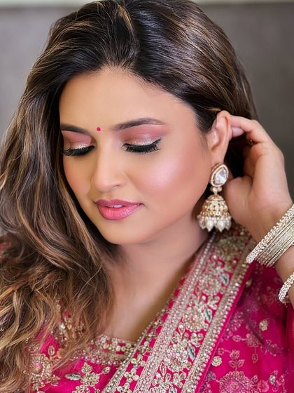 This client is beautifully adjusting her jhumka earring, part of a rental set. It shows the detail and quality of the pieces I offer for rent, perfect for completing your party look.