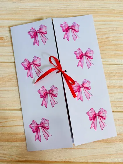 This is a "hugs card," which opens from the middle to reveal a big photo collage inside. It's tied shut with a simple red ribbon.