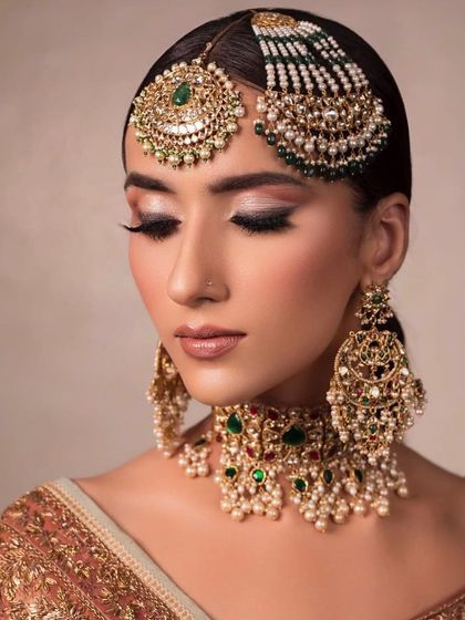 The same bridal look with eyes closed, showing the soft, shimmery eyeshadow and the perfect winged liner.