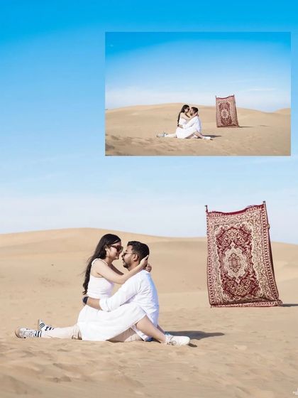 A whimsical desert scene with a "magic carpet" prop, where the couple shares an intimate moment on the sand under a clear blue sky.