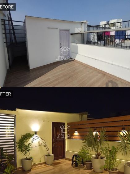 This empty entryway to the terrace is now a warm and welcoming space. We added a wooden slat wall, elegant planters, and ambient lighting to create a proper entrance.