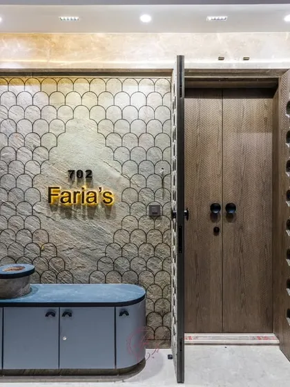 The main door in its open state, revealing a sturdy wooden inner door. This double-door system provides enhanced security while maintaining the exterior's intricate design, a practical solution by Jignesh.