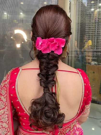 A beautiful braided hairstyle with fresh flowers for this lovely lady. It’s an elegant choice for matured hair.