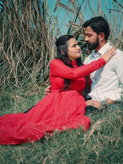 An intimate and romantic moment from an outdoor pre-wedding shoot, showing the couple's connection amidst nature.