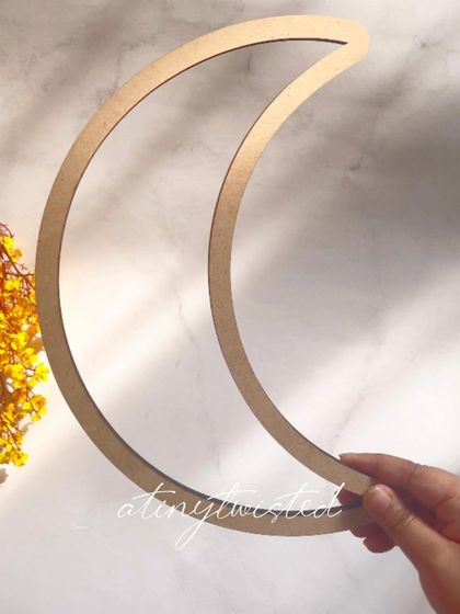 This is my 12-inch moon-shaped MDF frame. It's a versatile base perfect for creating macramé wall hangings, dreamcatchers, or unique mirrors for a nursery or boho-themed room.