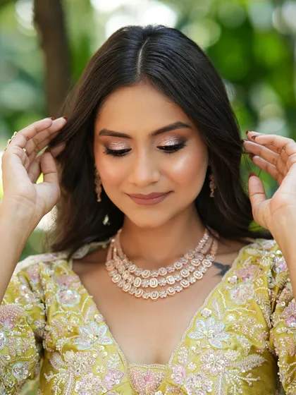Blended to perfection, glowing by intention. This close-up shows the flawless, shimmery eye makeup that catches the light beautifully.