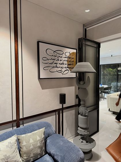 Another view of the calligraphy artwork in its home setting, complementing the modern and eclectic decor of the space.