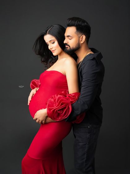 This couple is on fire. The bold red gown paired with the partner's all-black outfit creates a very passionate and glamorous look.