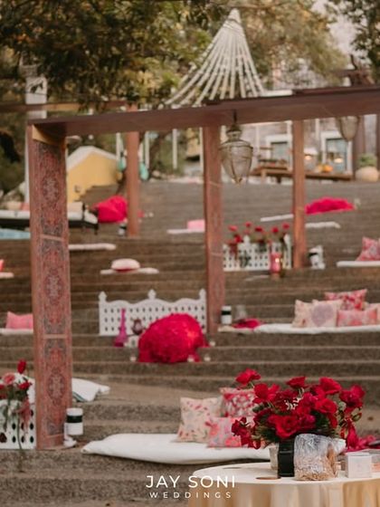 Another angle of the amphitheater-style seating, decorated with red umbrellas and floral arrangements, creating a vibrant and festive atmosphere.