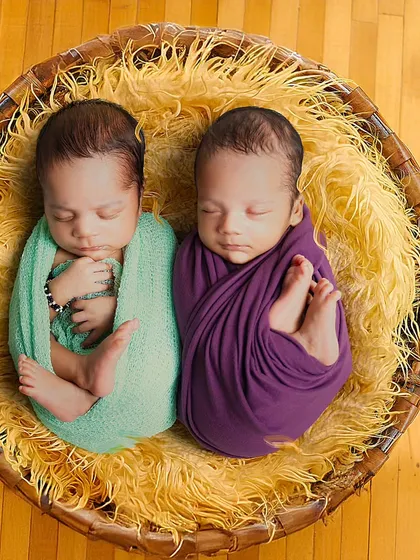 Double the joy. This photo shows my experience with twin newborn photography, with two babies swaddled snugly together in a rustic basket.