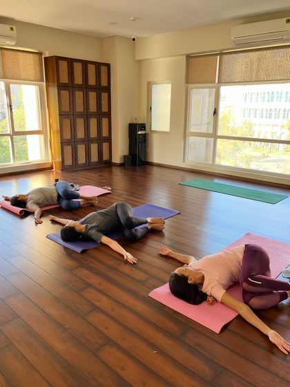 Embrace the art of untwisting and unraveling. A student rests in a gentle spinal twist, creating space and balance.