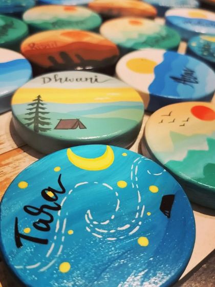 A duplicate of 59, an assortment of our travel-themed magnets, showing the variety of scenes we can create, including starry nights over a campsite and sunsets over the forest.