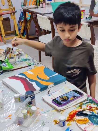 Scenes from our kids' acrylic workshop, where students learn to create bold and colorful landscape paintings.