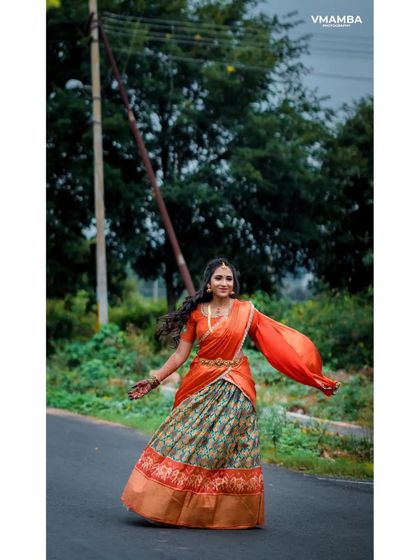 A playful and happy portrait of a bride-to-be, twirling in her beautiful engagement lehenga.