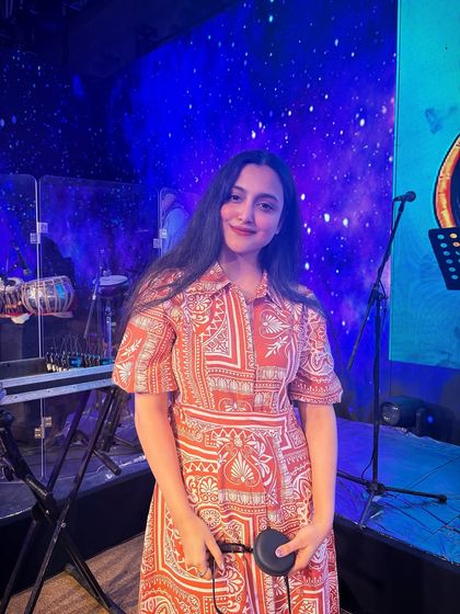 Another candid shot from Jaipur, holding my in-ear monitors. These are essential tools of the trade that help me deliver a flawless performance every time.