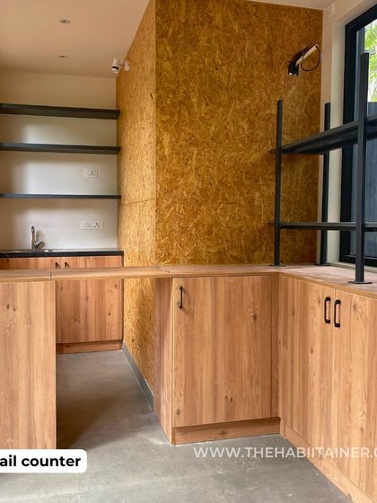 A duplicate of 93, this shot of the retail counter highlights the combination of natural wood cabinetry and a durable countertop, a practical and aesthetic choice for a commercial space.