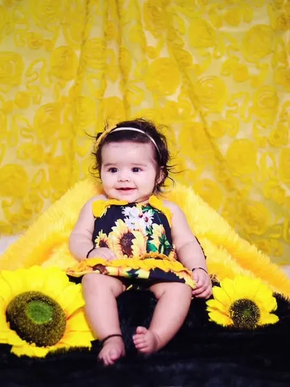 A wider view of the sunflower theme, showing the vibrant yellow backdrop and props.