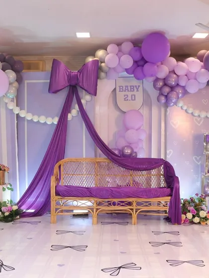 Bows are so in trend, and I loved designing this chic and modern baby shower around them. The combination of rich purple draping, a cascade of balloons, and custom details created a sophisticated yet playful atmosphere for the parents-to-be.