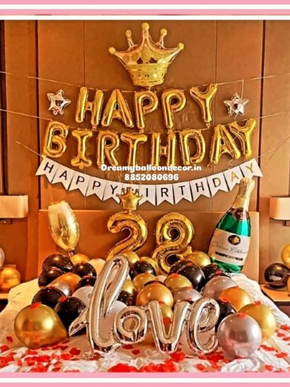 A grand birthday room decoration fit for a king or queen. This setup includes a 'Happy Birthday' banner, a crown foil balloon, a champagne bottle balloon, and personalized age numbers.