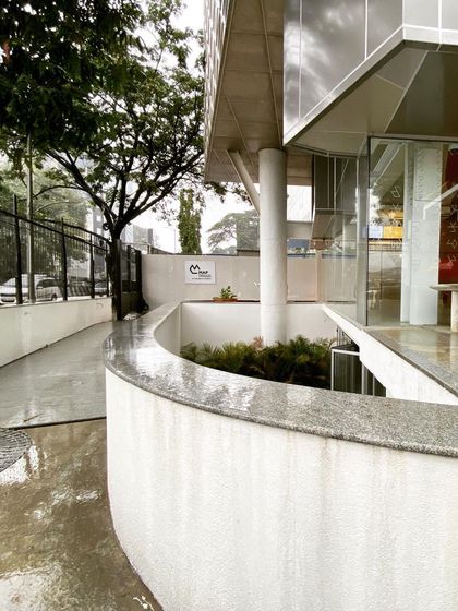 The entrance to MAP on a rainy day. The architecture is designed to be experienced in all weather, with the wet surfaces reflecting light and the covered walkways providing shelter.