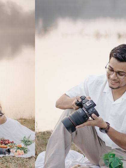 A candid shot of the groom-to-be reviewing photos on his camera during their pre-wedding picnic.