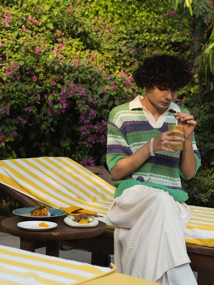 Enjoying a refreshing drink on our comfortable, yellow-striped loungers is a quintessential Anvaya experience.