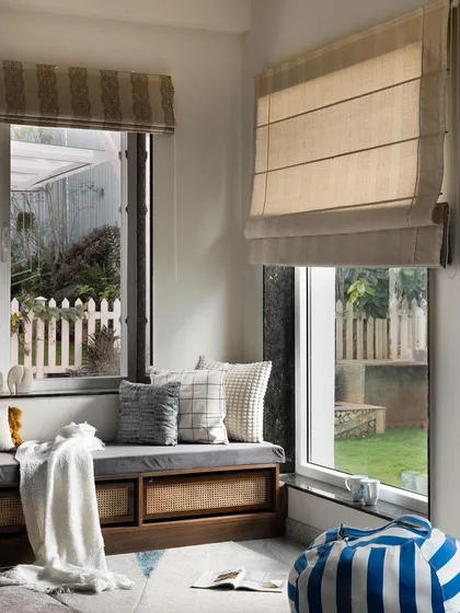 This cozy window seat is the perfect reading nook. We designed it with built-in storage and comfortable cushions, creating a functional and charming spot to enjoy the garden view.