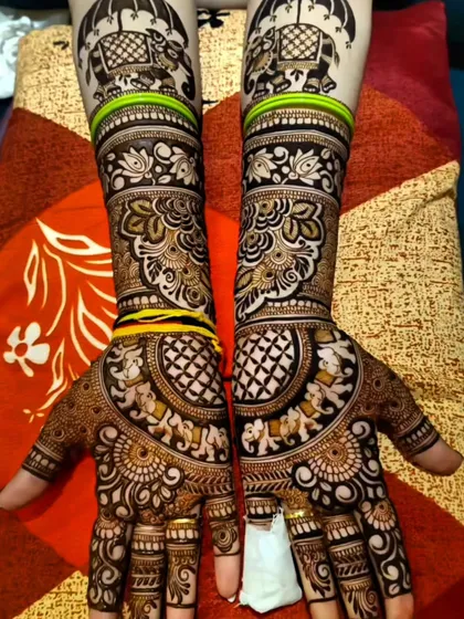 A classic Rajasthani bridal design featuring majestic elephants under ceremonial umbrellas. The fine lines, detailed patterns, and symmetrical layout create a grand and traditional look, perfect for a bride's special day.