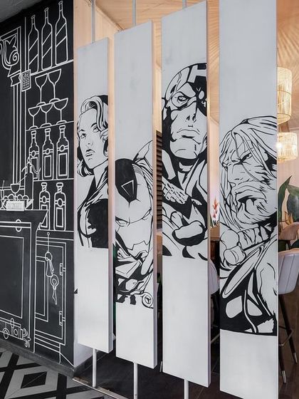 Detail of the rotating panels and the bar mural in our sketch-themed restaurant. This approach allowed us to create a space that is not only visually striking but also flexible and engaging for patrons.