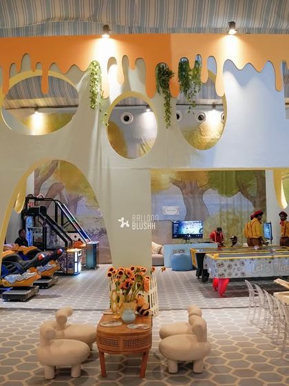 A large, custom-built soft play area designed to look like a honey-drip house, providing a safe and on-theme space for the youngest guests.