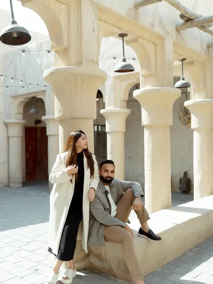 A stylish, editorial-style portrait of Dolly and Dhairya in Dubai. The clean lines of the architecture and their modern outfits create a chic and contemporary pre-wedding look.