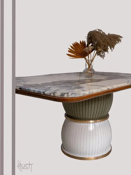 The 'Damru' dining table, inspired by the musical instrument, stands on two spheres and is topped with beautiful Brazilian Quartzite.