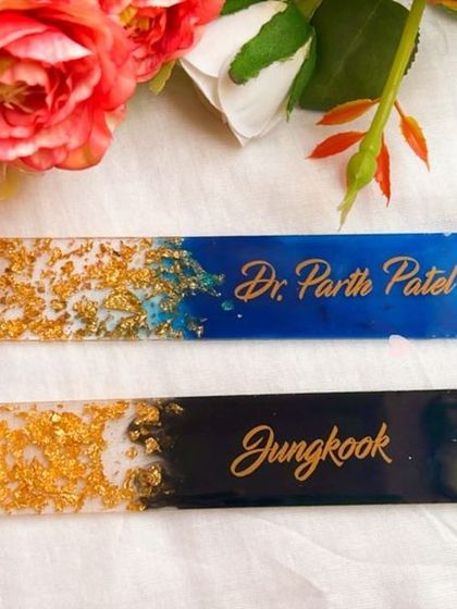 Here are two custom bookmarks ready to be sent out. One is a rich black and gold design for a K-pop fan, and the other is a blue and gold design for a doctor.