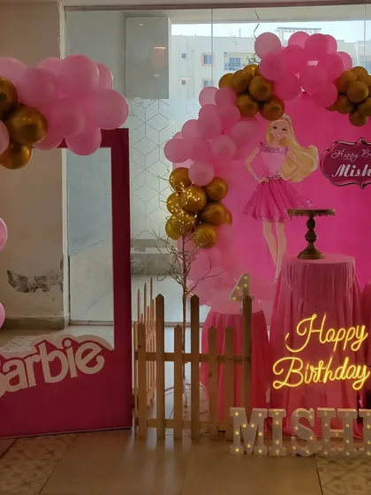 A stylish Barbie theme party in signature pink and gold. This decoration includes a circular backdrop with a Barbie silhouette, a life-size Barbie photo box for fun pictures, and a neon 'Happy Birthday' sign for a modern touch.