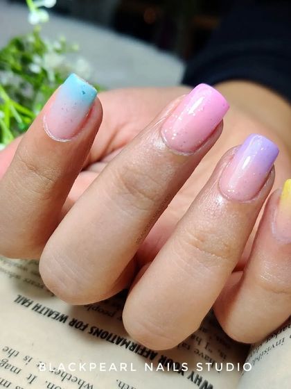 A beautiful pastel ombré set where each nail tells a colorful story. The soft gradients of blue, pink, purple, and yellow create a dreamy and enchanting manicure.