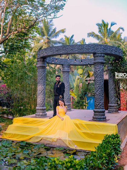 A couple with a flowing yellow gown at our stone gazebo, a bright and cheerful image.