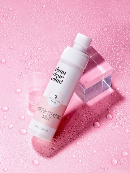 To highlight the hydrating quality of this makeup removing mist, we surrounded it with water droplets on a matching pink surface. The acrylic block adds a modern, geometric element that contrasts beautifully with the organic feel of the water.