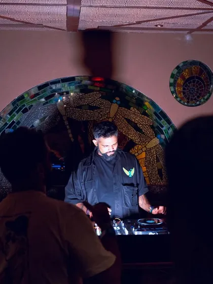 A shot of me at the decks at Waikiki, with the club's beautiful mosaic art in the background.