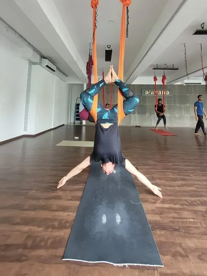 An upside-down perspective from our aerial class. This inversion, supported by the hammock, helps decompress the spine and brings fresh oxygen to the brain.