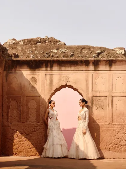 Two stunning ivory looks from the Awigna campaign, set against a beautiful rustic backdrop. Perfect inspiration for a bride and her sister or bridesmaid.