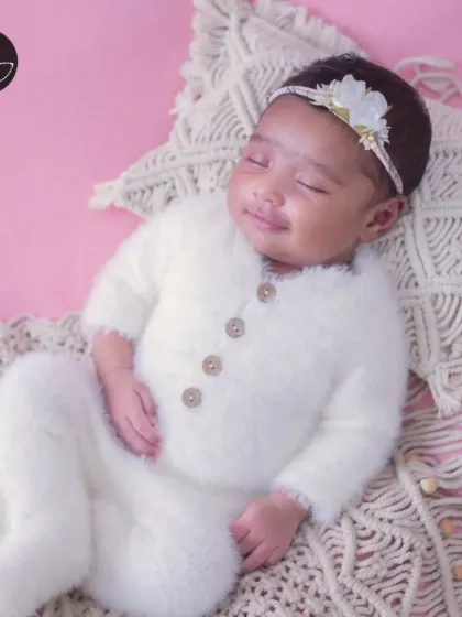 A heart-melting smile from a sleeping newborn, showcasing the pure joy and innocence of a new life.