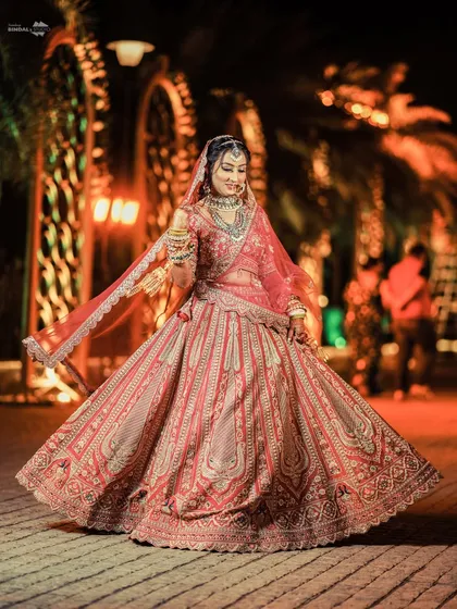 Every bride deserves her moment to shine. This portrait captures the pure joy and elegance of a bride in her stunning wedding lehenga, a timeless image of grace and happiness.