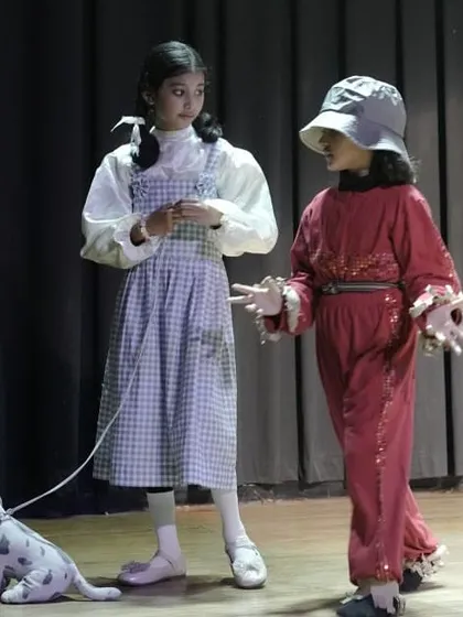 Dorothy and the Scarecrow in a scene from 'The Wizard of Oz'. This highlights character interaction and the use of props to enhance storytelling.
