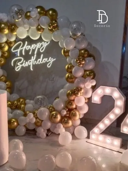 A classic and elegant 24th birthday setup in gold and white. The decor features a circular balloon arch with a neon sign, a white pedestal, and '24' marquee numbers, perfect for a timeless celebration.
