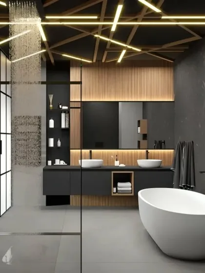 We transform bathrooms into personal spas, like this stunning example. It features a freestanding bathtub, a separate glass-enclosed rain shower, and dramatic ceiling lighting, all set against dark, textured walls and wood accents to create a moody and luxurious escape.