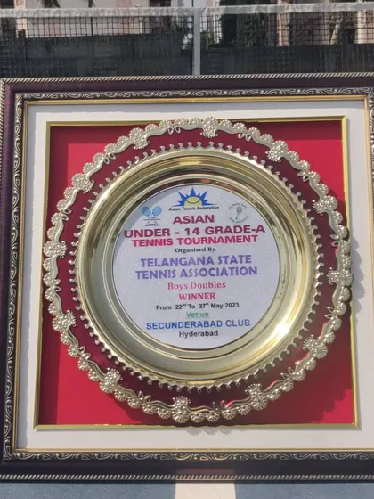 This plaque represents a significant victory. It's the winner's trophy from the Asian Under-14 Grade A Tournament in Hyderabad, won by our trainee Om Verma in the doubles event.