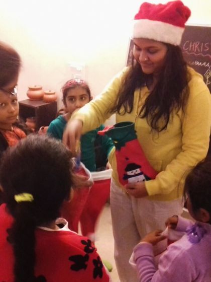 An invitation to our special half-day Christmas retreat for kids and parents, featuring a photo of a past event where children received gifts.