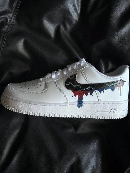 A custom Nike Air Force 1 with a dripping galaxy-themed swoosh.